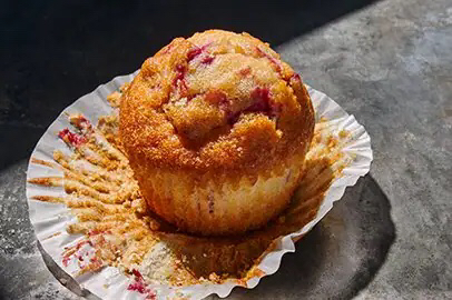 Picture of a cranberry orange muffin in its wrapper.