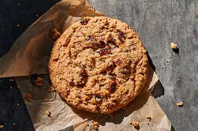 Picture of a raisin berry cookie on a napkin.