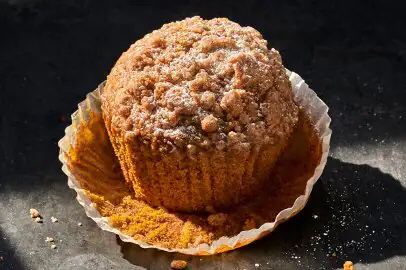 Picture of a pumpkin muffin in its wrapper.